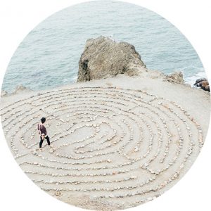 A person walking through a rock maze