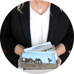 A photo of Laura Cole holding a deck of horse card photos